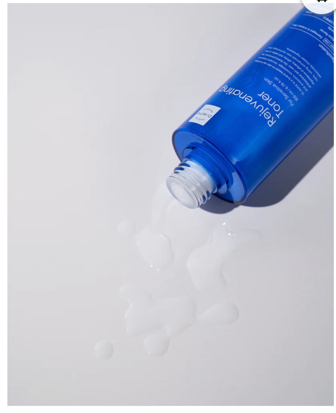 Blue bottle with white cap on a light gray background